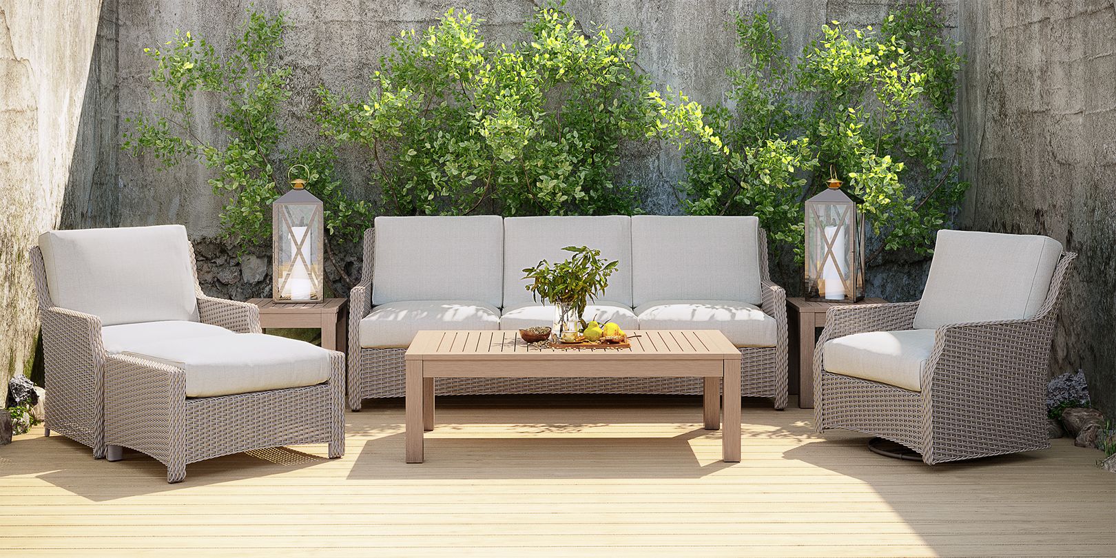Photo of gray wicker patio seating set with ivory cushions and a set of teak tables