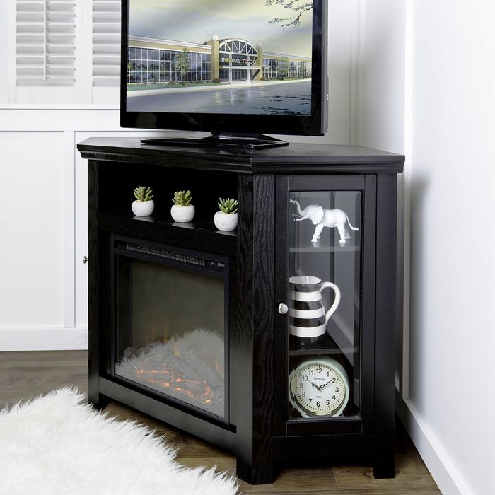 a black tv console decorated with black and white accents