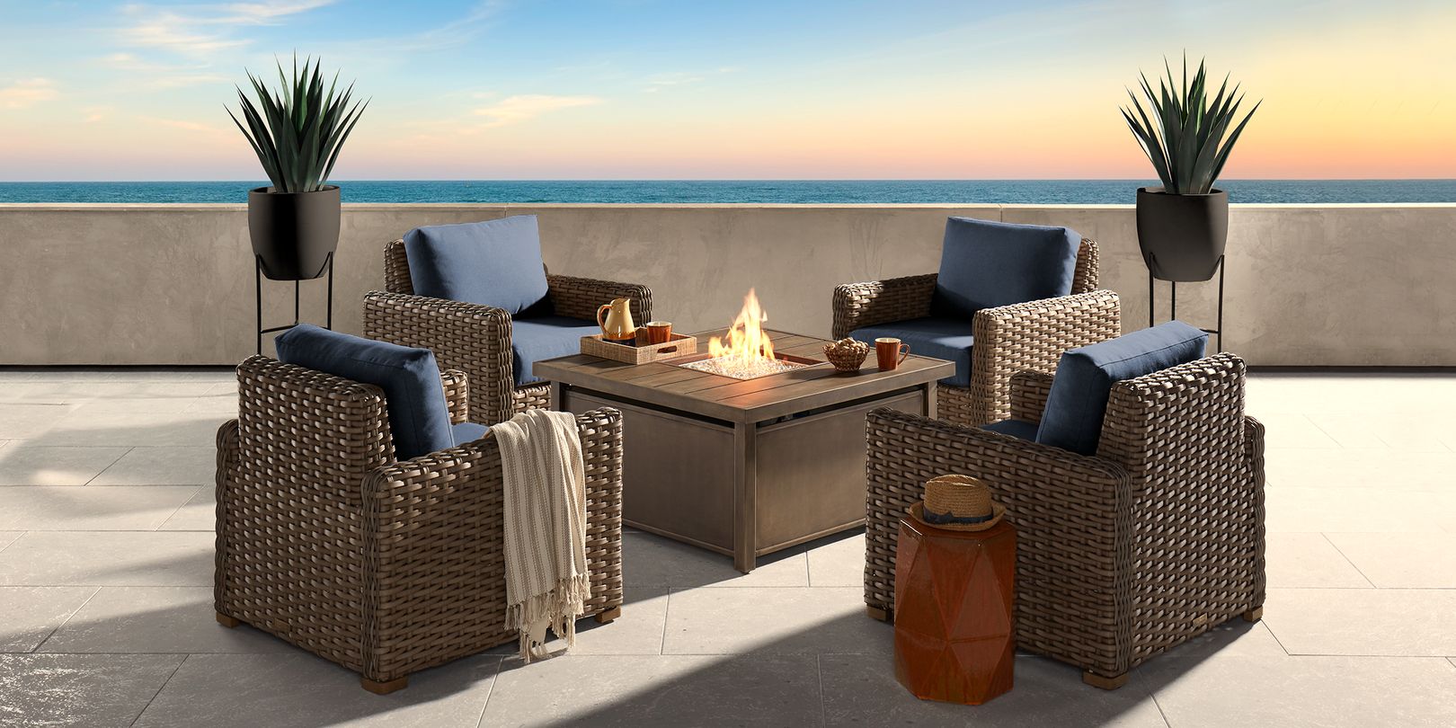Photo of four wicker outdoor chairs and fire pit table
