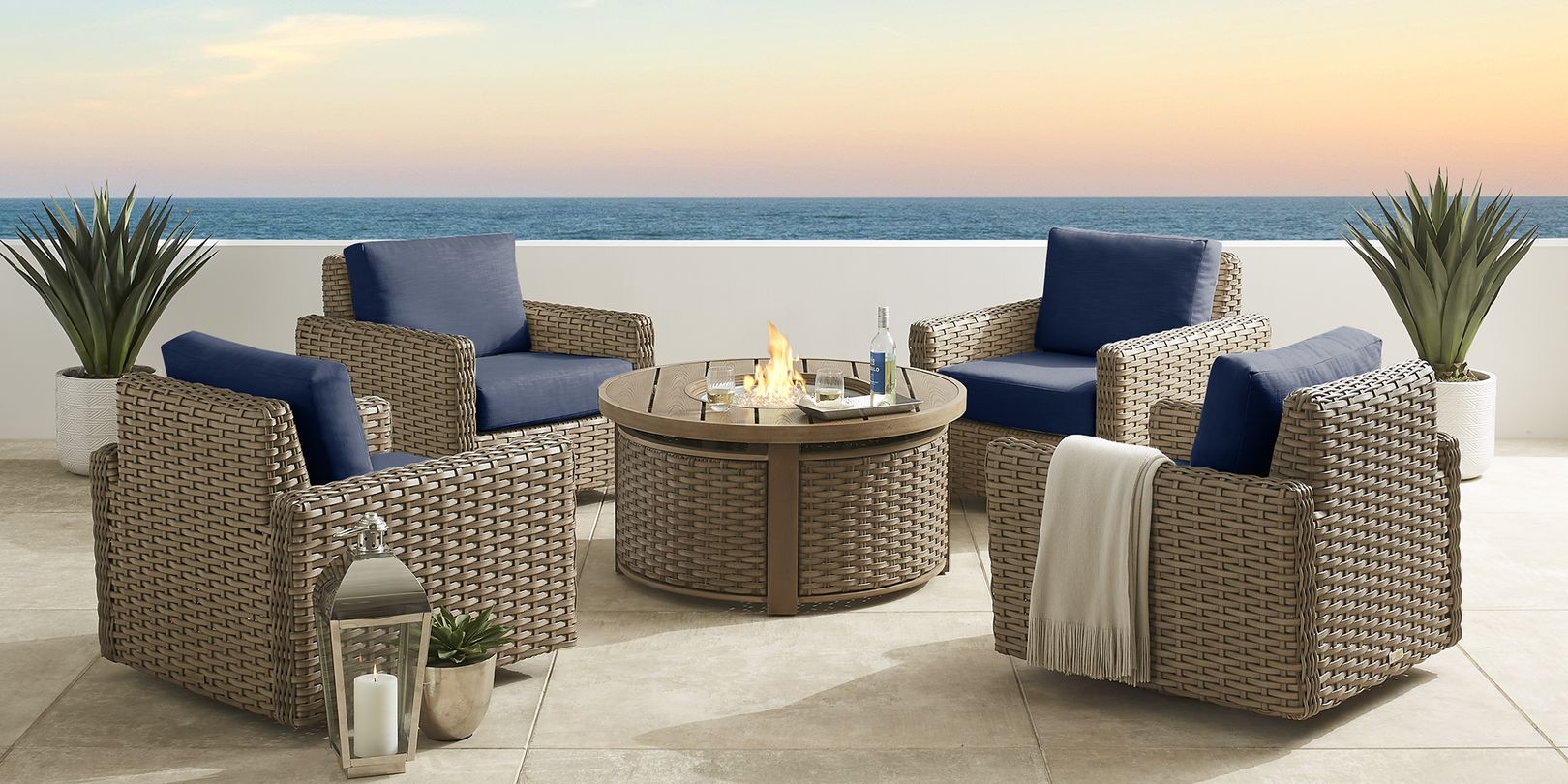 Photo of wicker fire pit surrounded by four wicker patio chairs