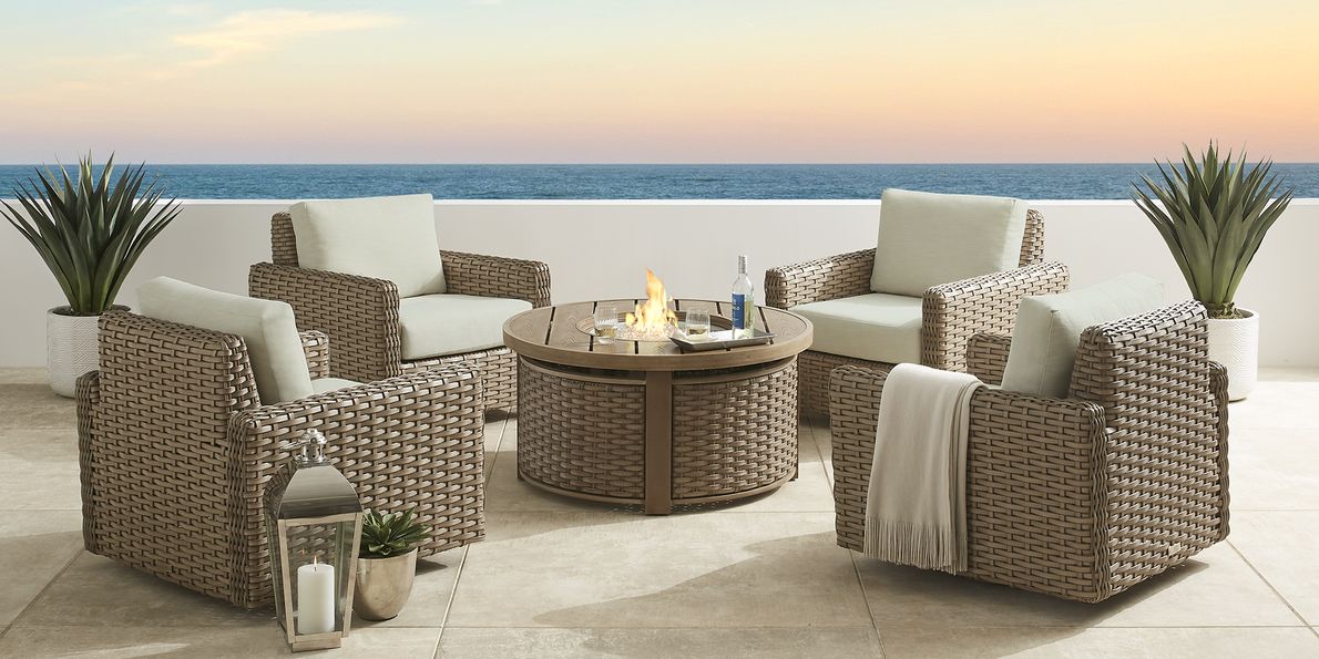 photo of four wicker patio club chairs around a wicker fire pit