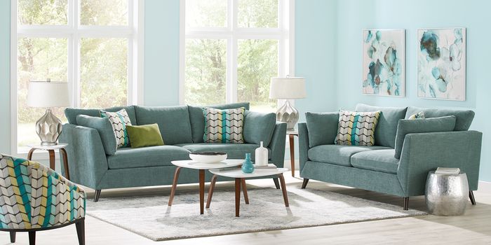 teal living room set with patterened pillows and accent chair