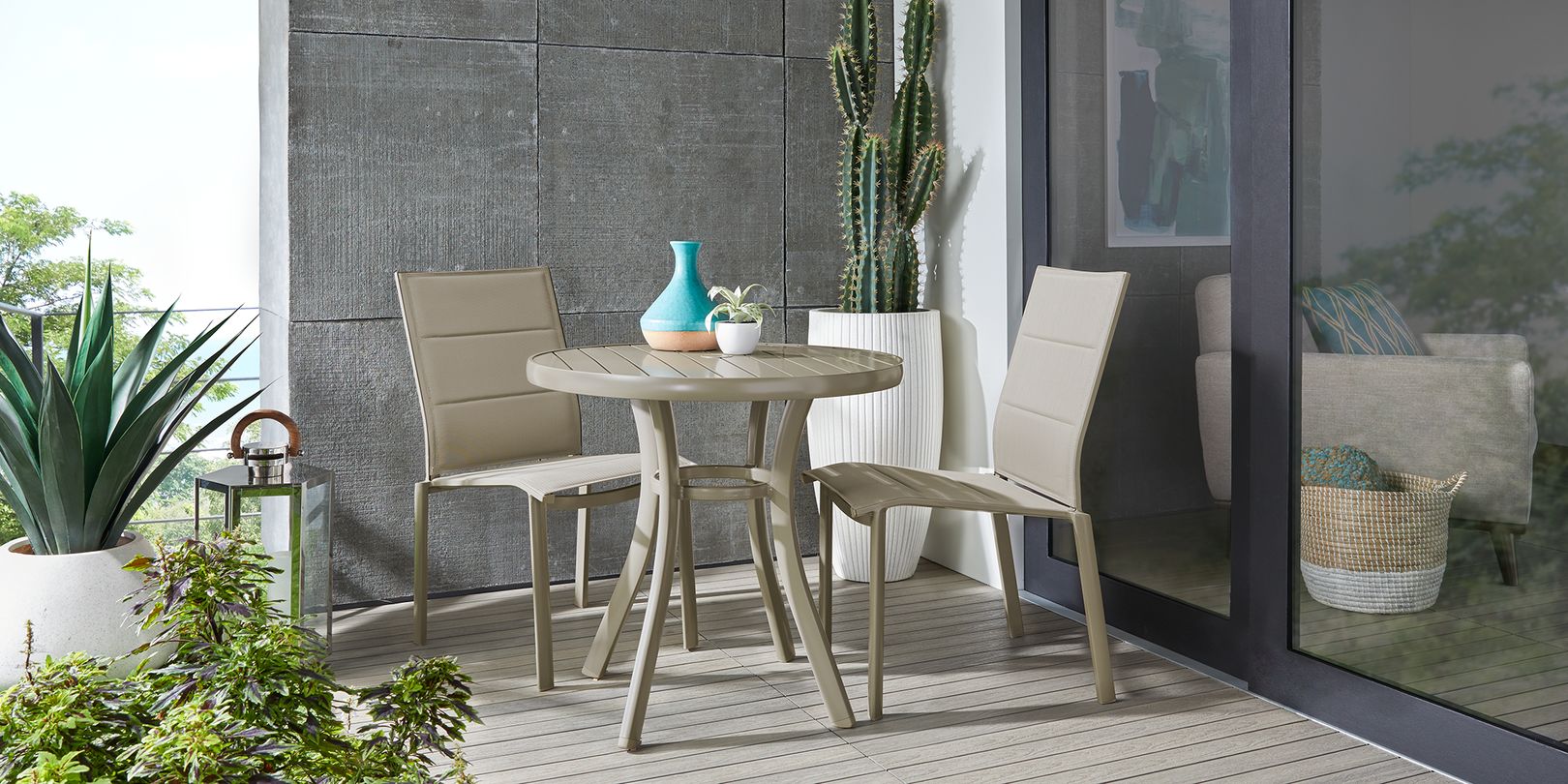 Photo of small tan dining set on a balcony with plants