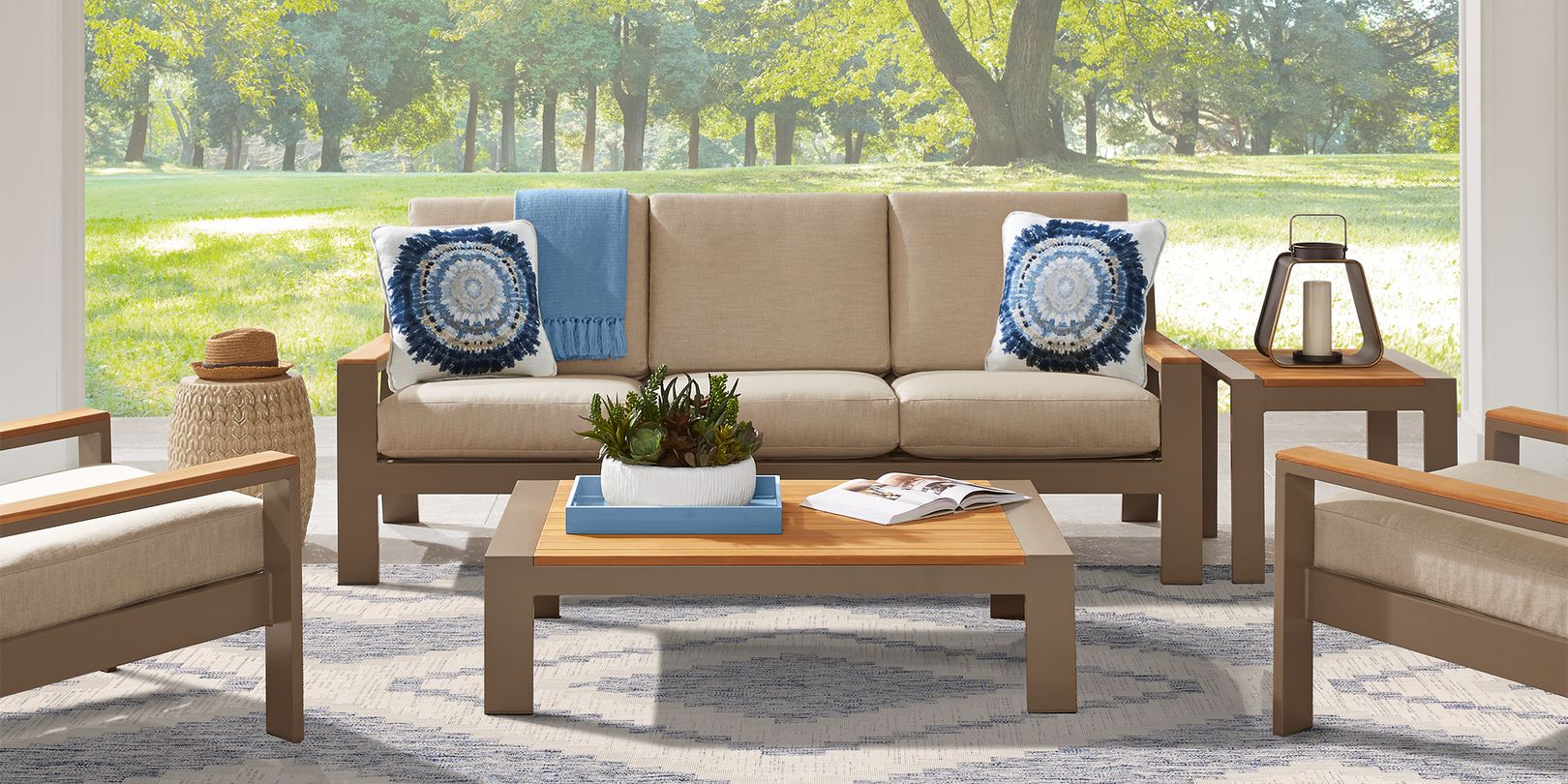 Photo of taupe patio seating set with cushions and tables