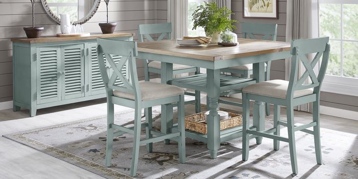 dining room table with plants and place settings