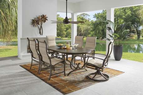 Outdoor dining set with a table, chairs, and a rug.
