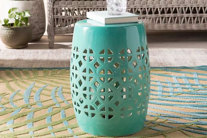 porcelain aqua blue mesi stool with book on top 