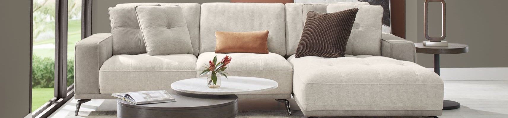 Beige sectional sofa with decorative pillows.
