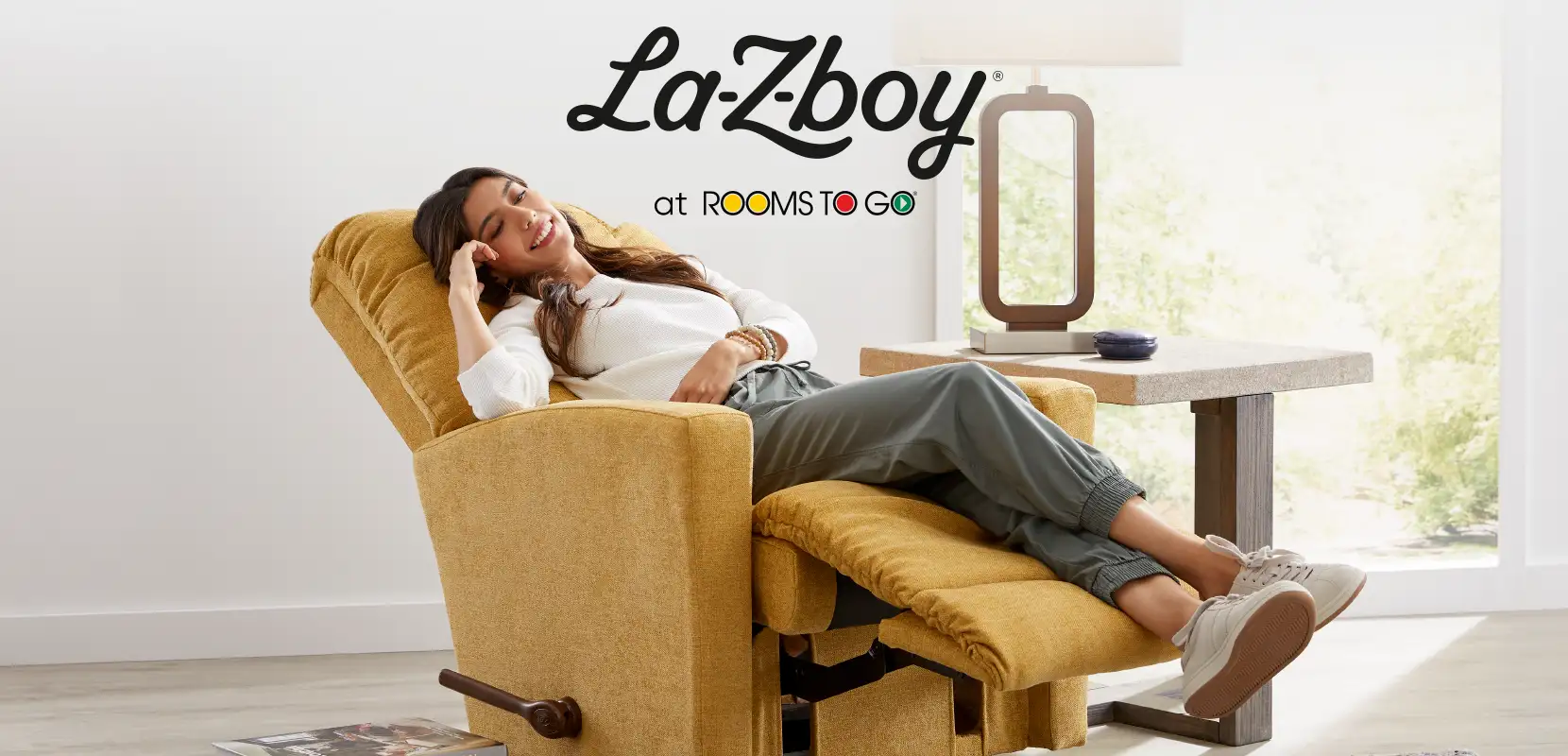 La-Z-Boy at Rooms To Go. A woman relaxes in a yellow recliner.
