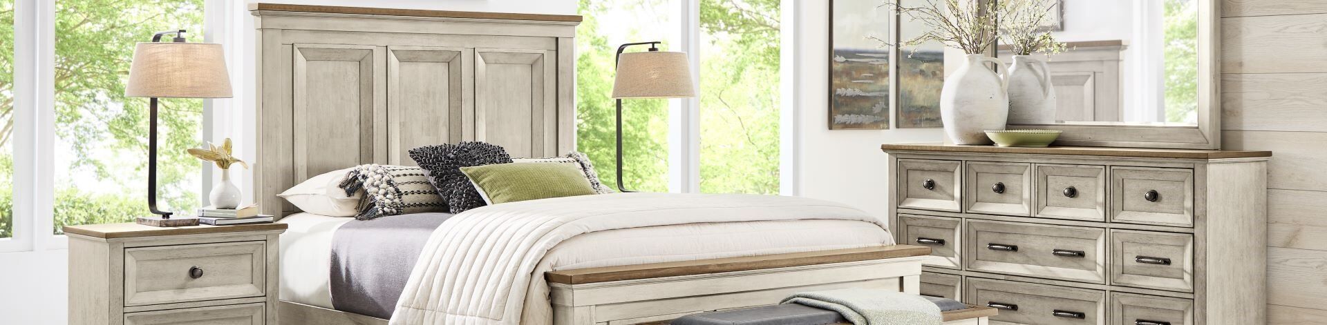 Bedroom furniture set with a bed, nightstand, and dresser.
