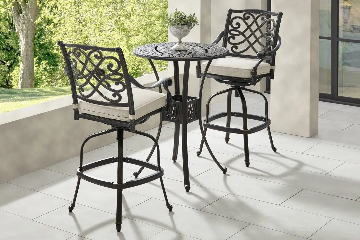 Outdoor bar set with two chairs and a small table.
