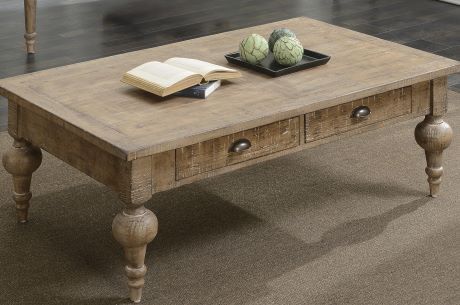 Wooden coffee table with two drawers, a book, and decorative spheres.
