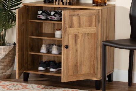 Wooden shoe cabinet with open doors, holding shoes on shelves.
