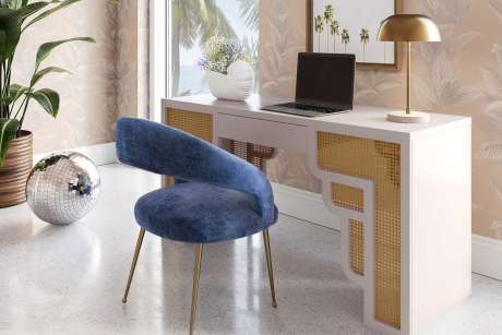 A desk with a blue chair, a disco ball, and a lamp.
