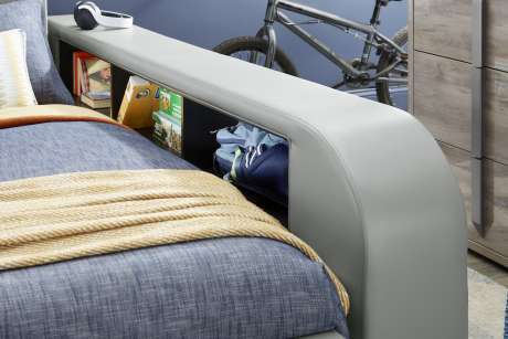 Bed with built-in storage and a headboard shelf.
