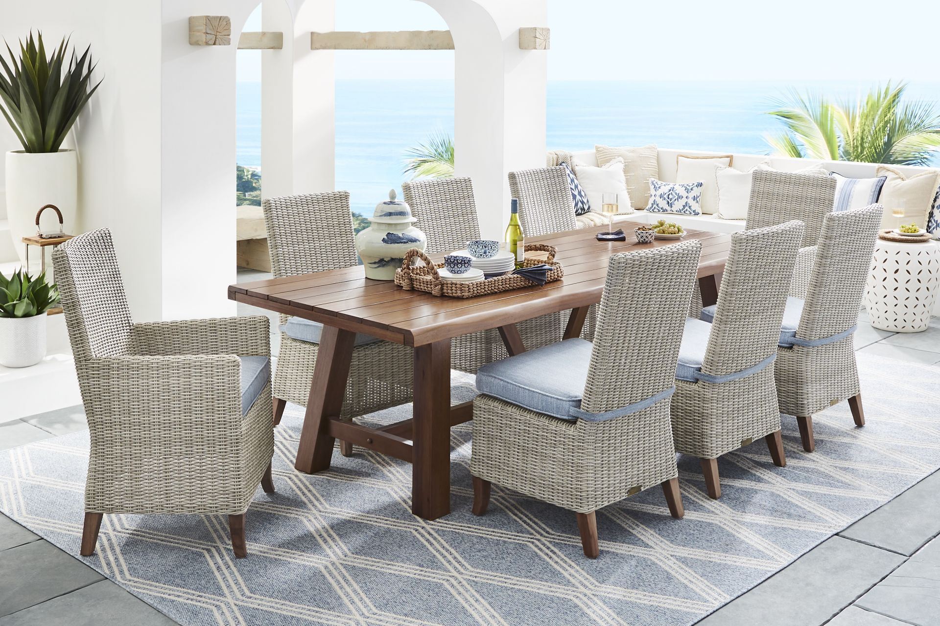 Patmos Tan 7 Pc 102 in. Rectangle Outdoor Dining Set With Steel Cushions - Image 1