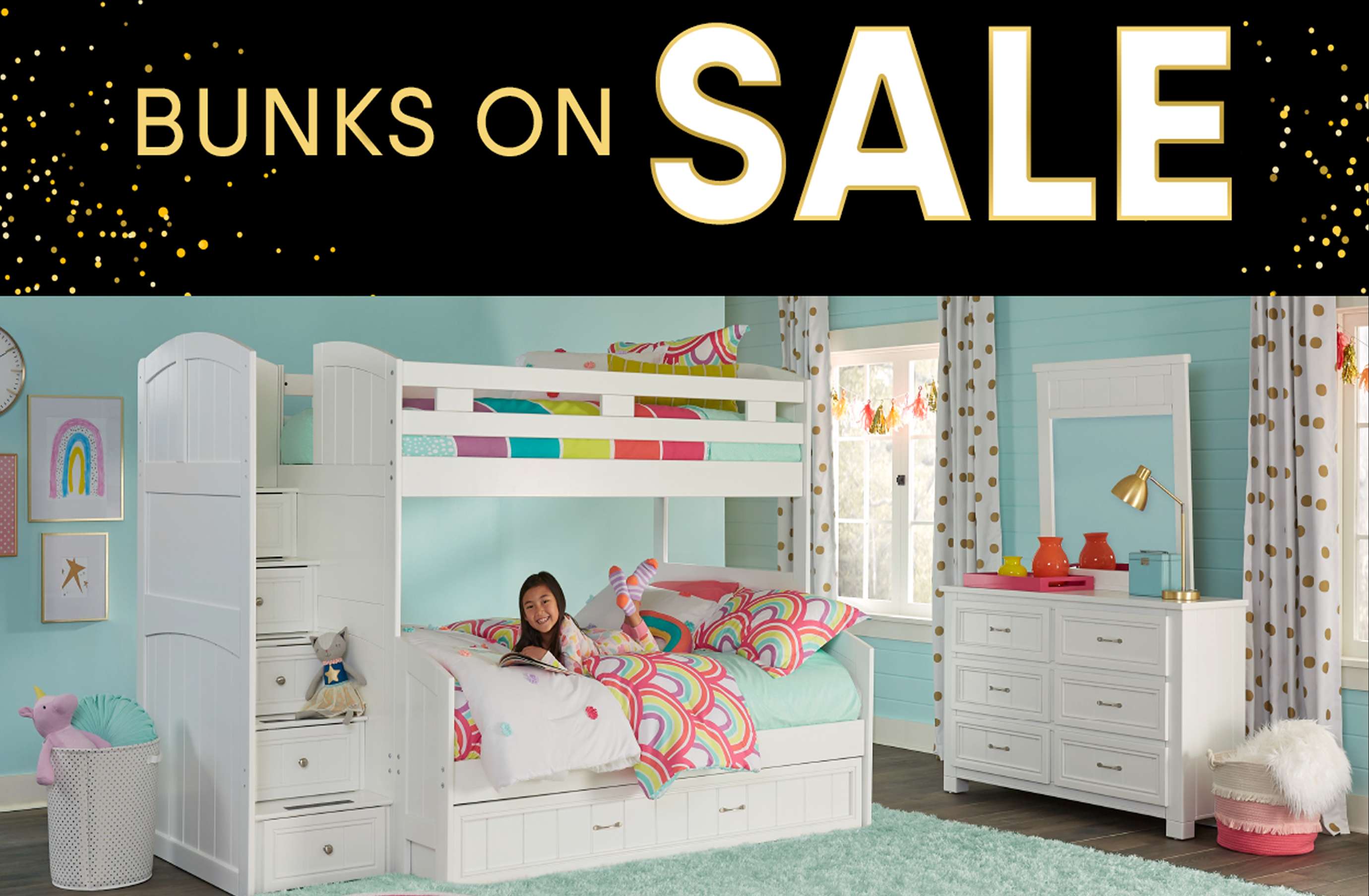 Bunks on Sale. A white bunk bed with a girl lying on the bottom bunk.
