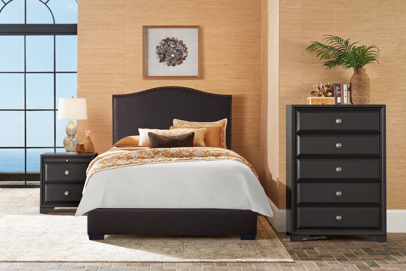 Bedroom furniture set with a bed, nightstand, and dresser.
