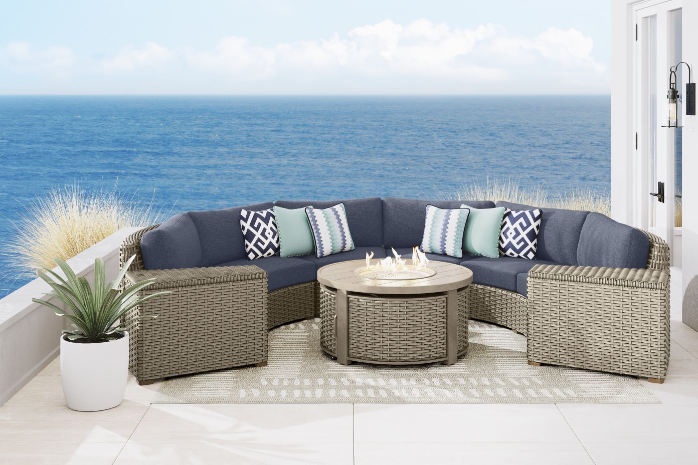 Outdoor sectional sofa with a fire pit table and storage ottomans.
