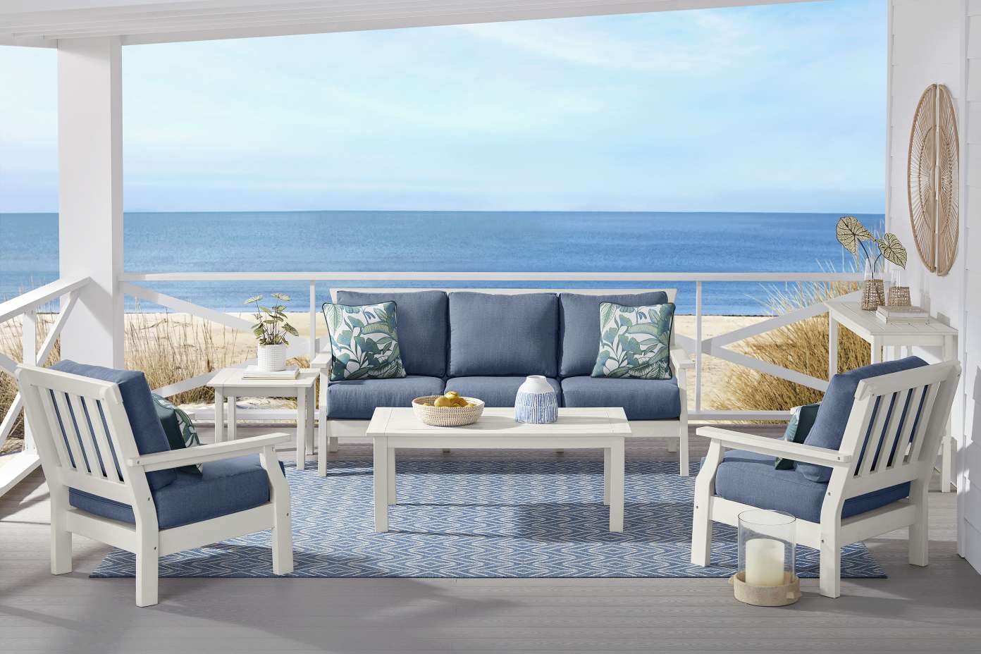 Outdoor patio furniture set with a view of the ocean.
