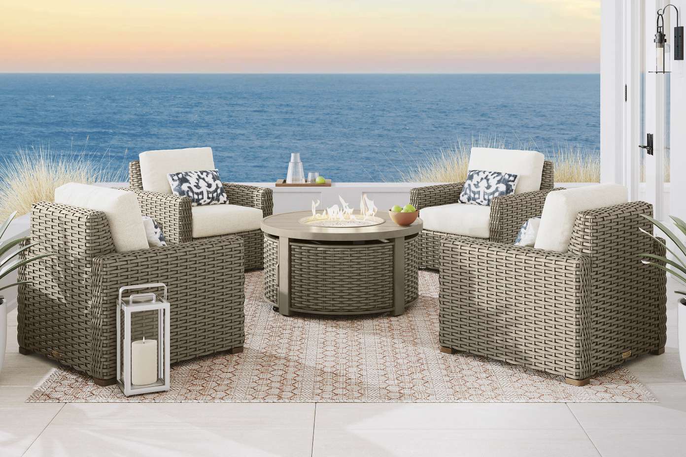 Outdoor seating set with a fire pit and ocean view.
