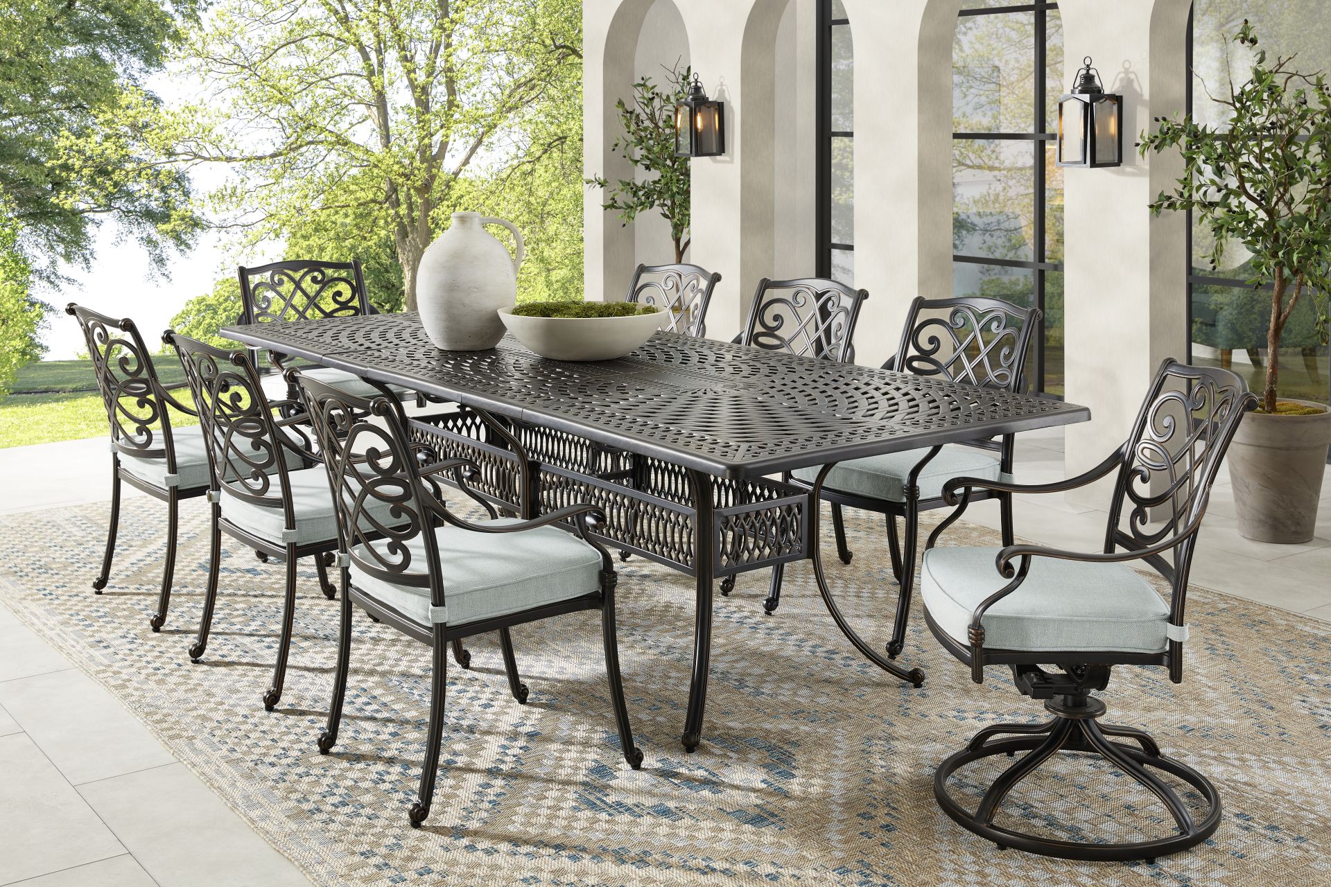 Carina Bronze 9 Pc 87-112 in. Rectangle Extension Outdoor Dining Set with Sky Cushions - Image 1