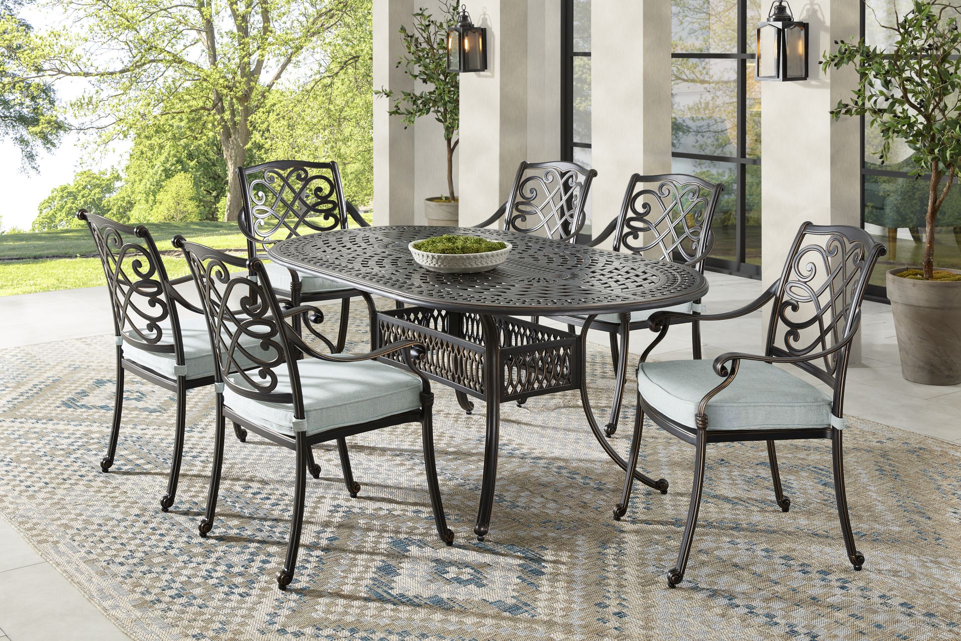 Carina Bronze 7 Pc Oval Outdoor Dining Set with Sky Cushions - Image 1
