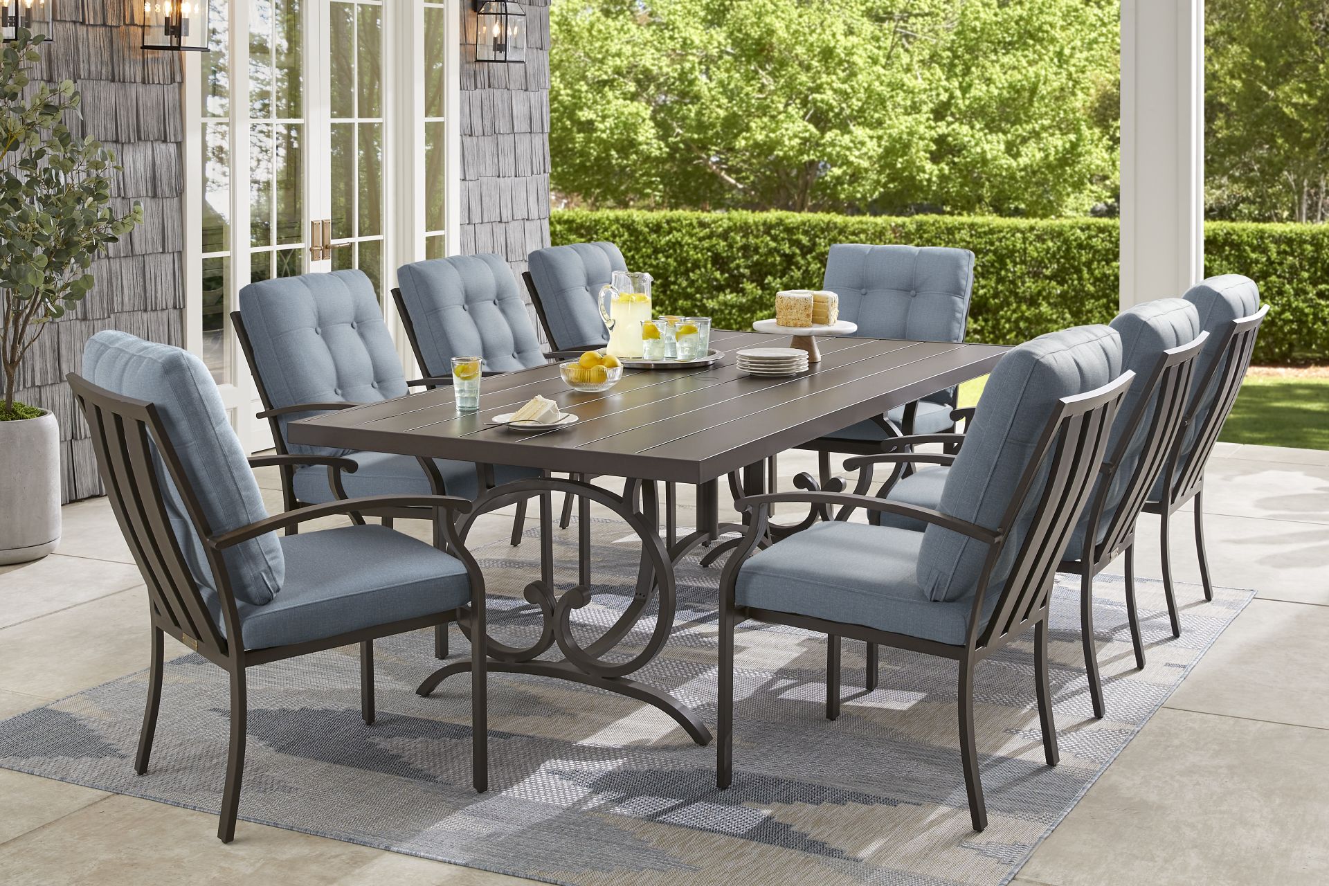 Lake Breeze Aged Bronze 9 Pc Outdoor Dining Set with Blueberry Cushions - Image 1