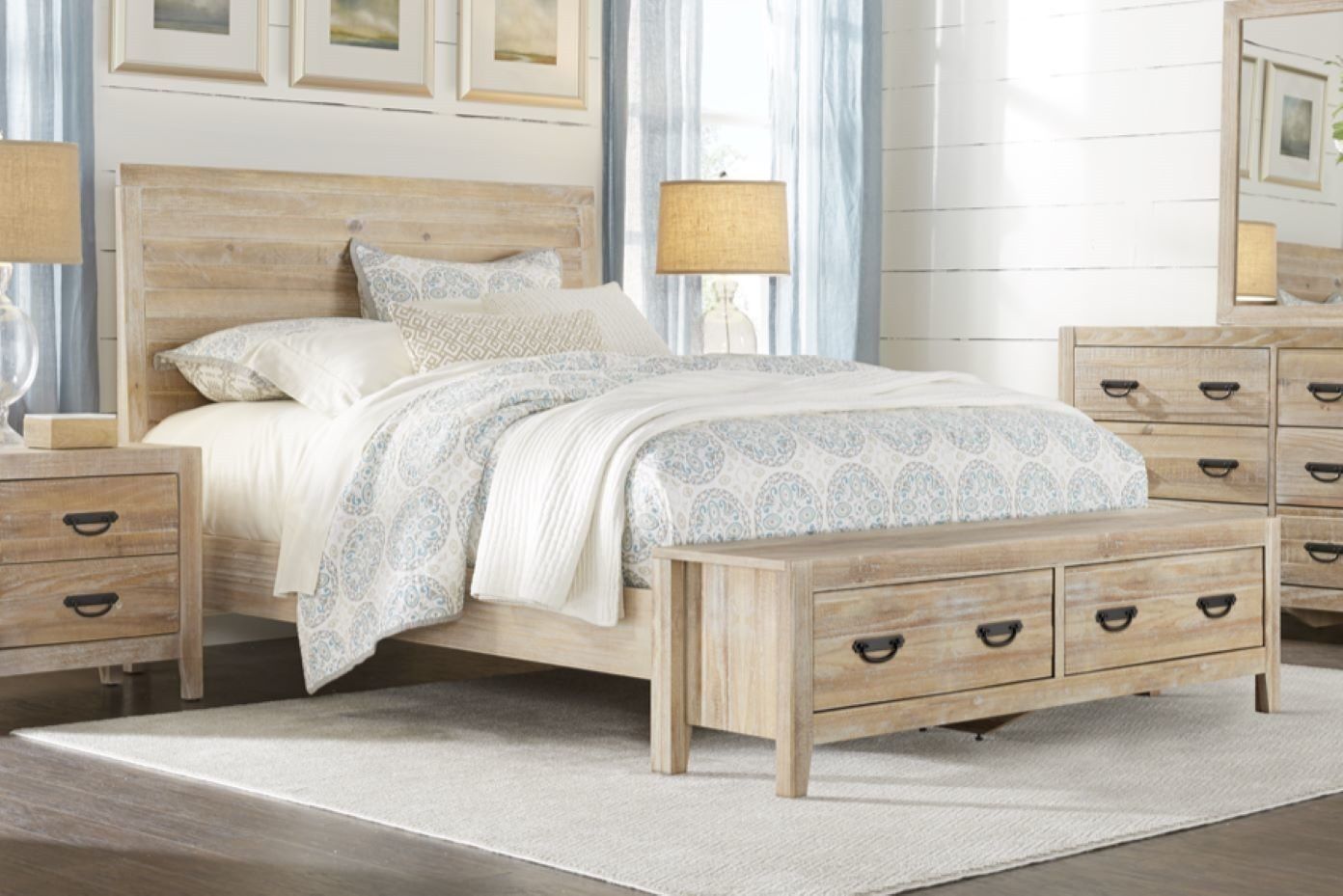 Bedroom furniture set with a bed, nightstand, dresser, and bench.
