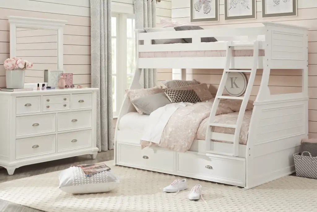 White bunk bed with a dresser and mirror in a bedroom.
