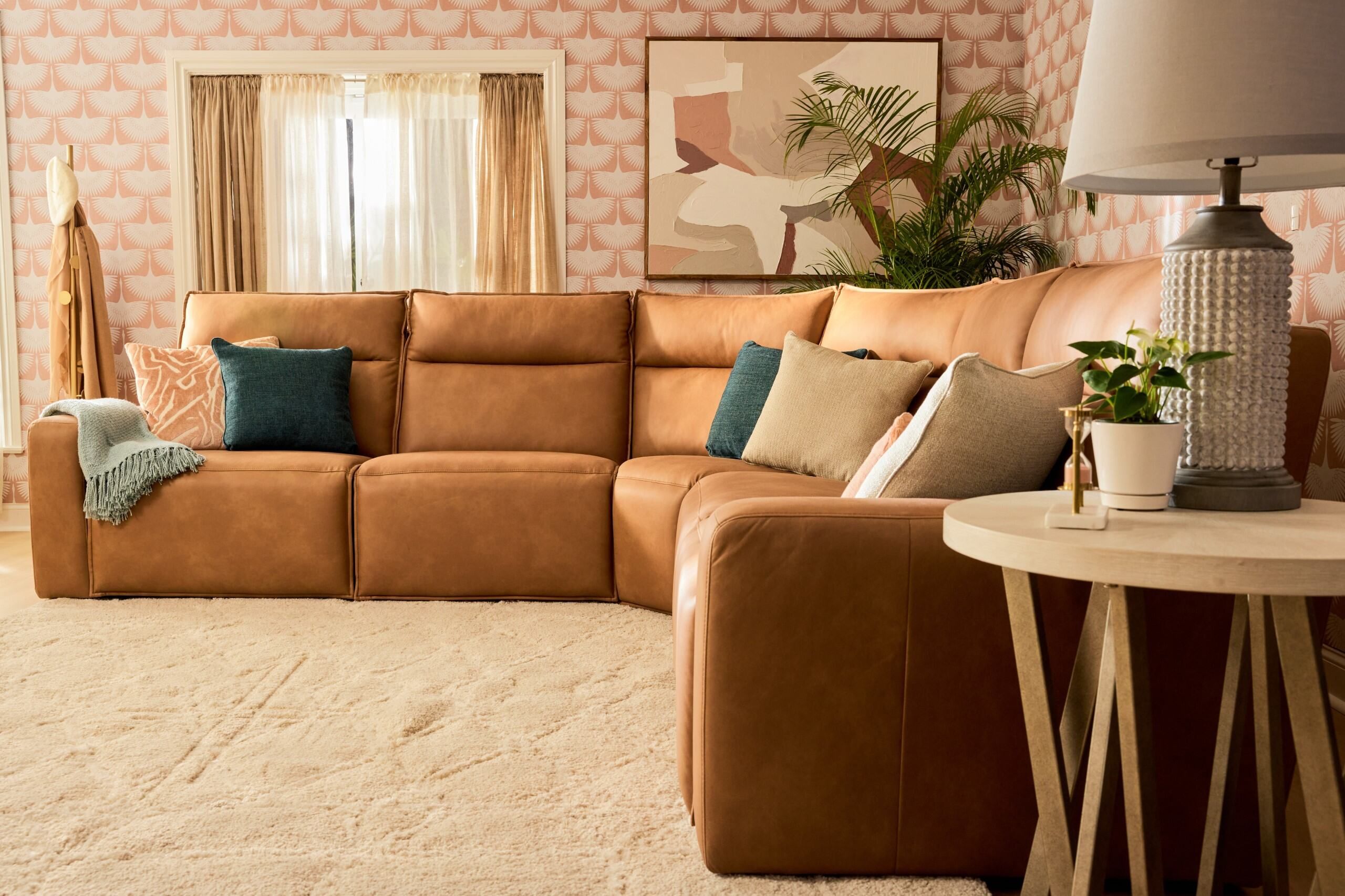 Brown leather sectional sofa in a living room.
