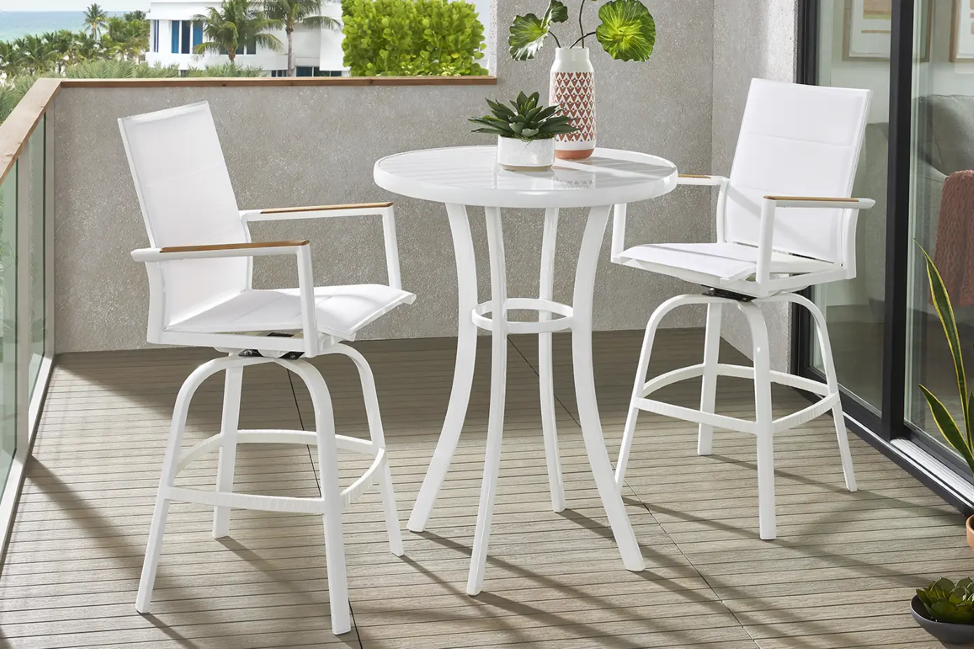 White outdoor bar table and chairs.
