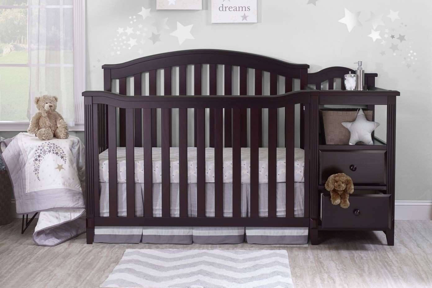 Dark brown crib with attached changing table.