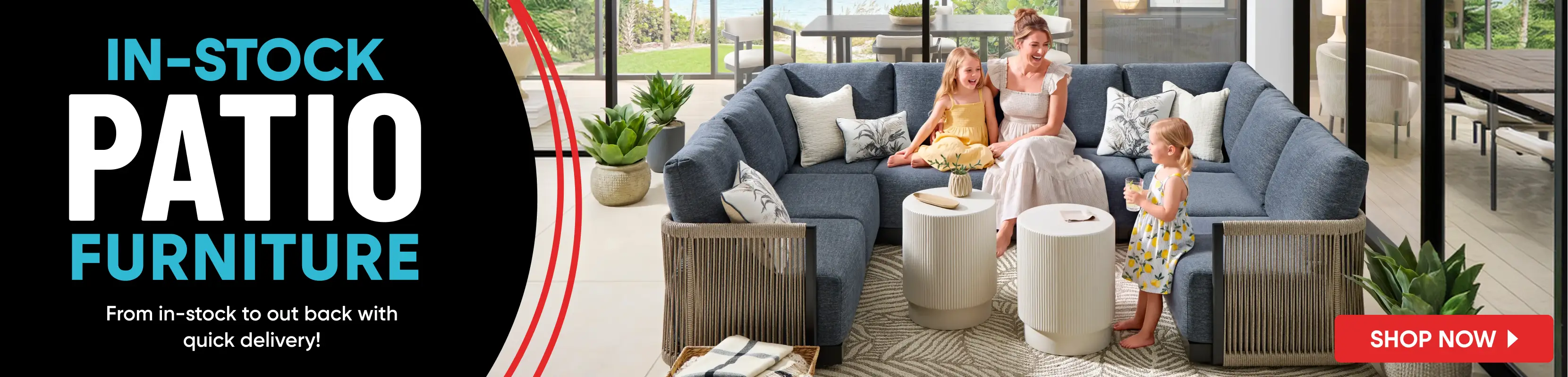 IN-STOCK PATIO FURNITURE: A woman and two children sit on a blue sectional sofa on a patio with two white side tables.