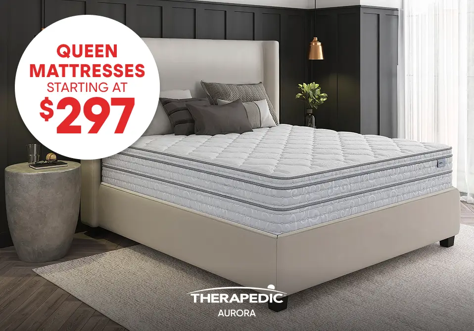 Queen mattresses starting at $297, featuring a Therapedic Aurora mattress on a bed frame in a modern bedroom.