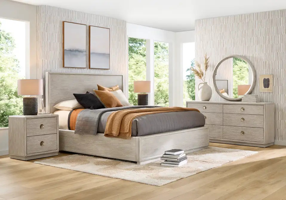 Bedroom furniture set with a bed, nightstand, dresser, and rug.
