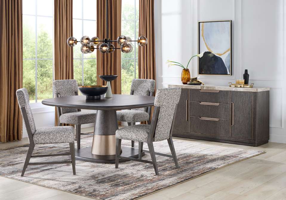 Dining room set with a round table, chairs, and a sideboard.

