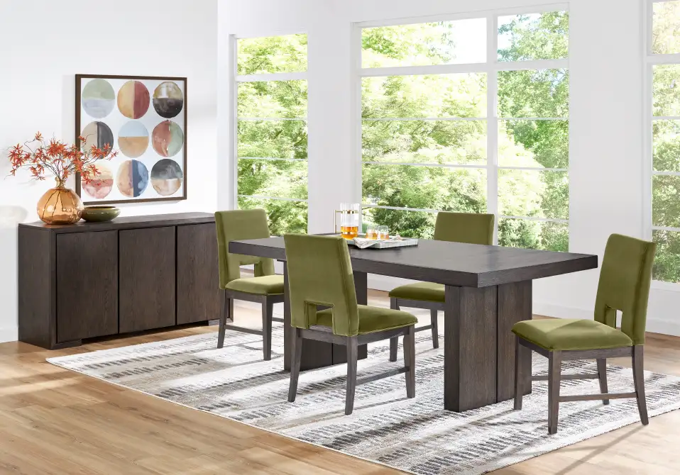 Dining room set with a dark wood table, green chairs, and a matching sideboard.
