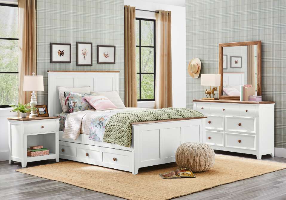 Bedroom set with a white bed, dresser, and nightstand with brown accents.
