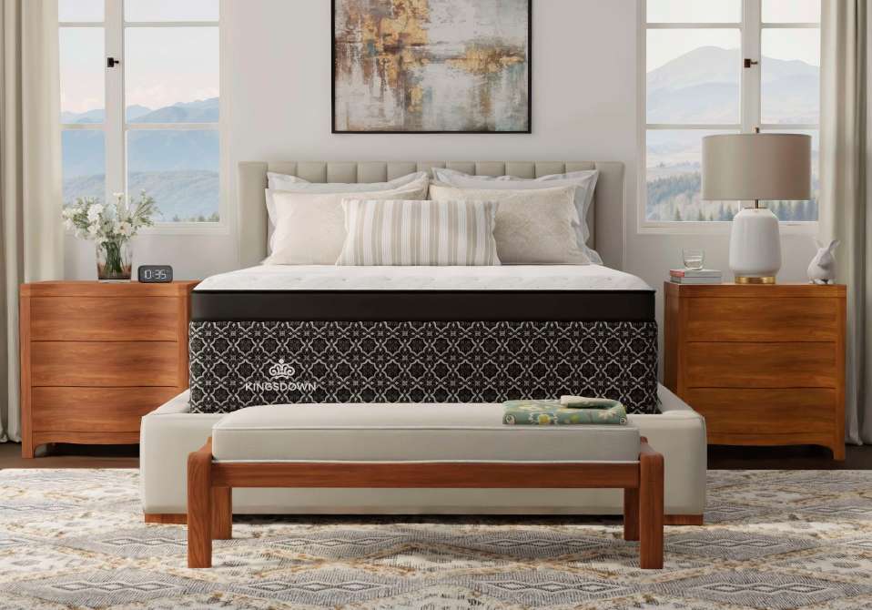 Kingsdown mattress. Bedroom with a bed, nightstands, and a bench.
