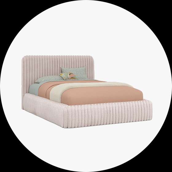 Pink corduroy bed with a headboard and pillows.
