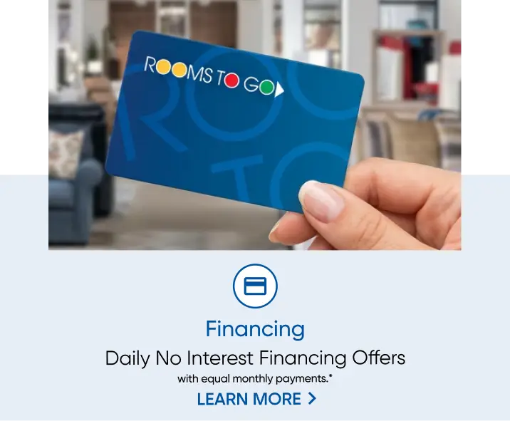 Rooms To Go Financing: Daily No Interest Financing Offers with equal monthly payments. A hand holds a Rooms To Go credit card.