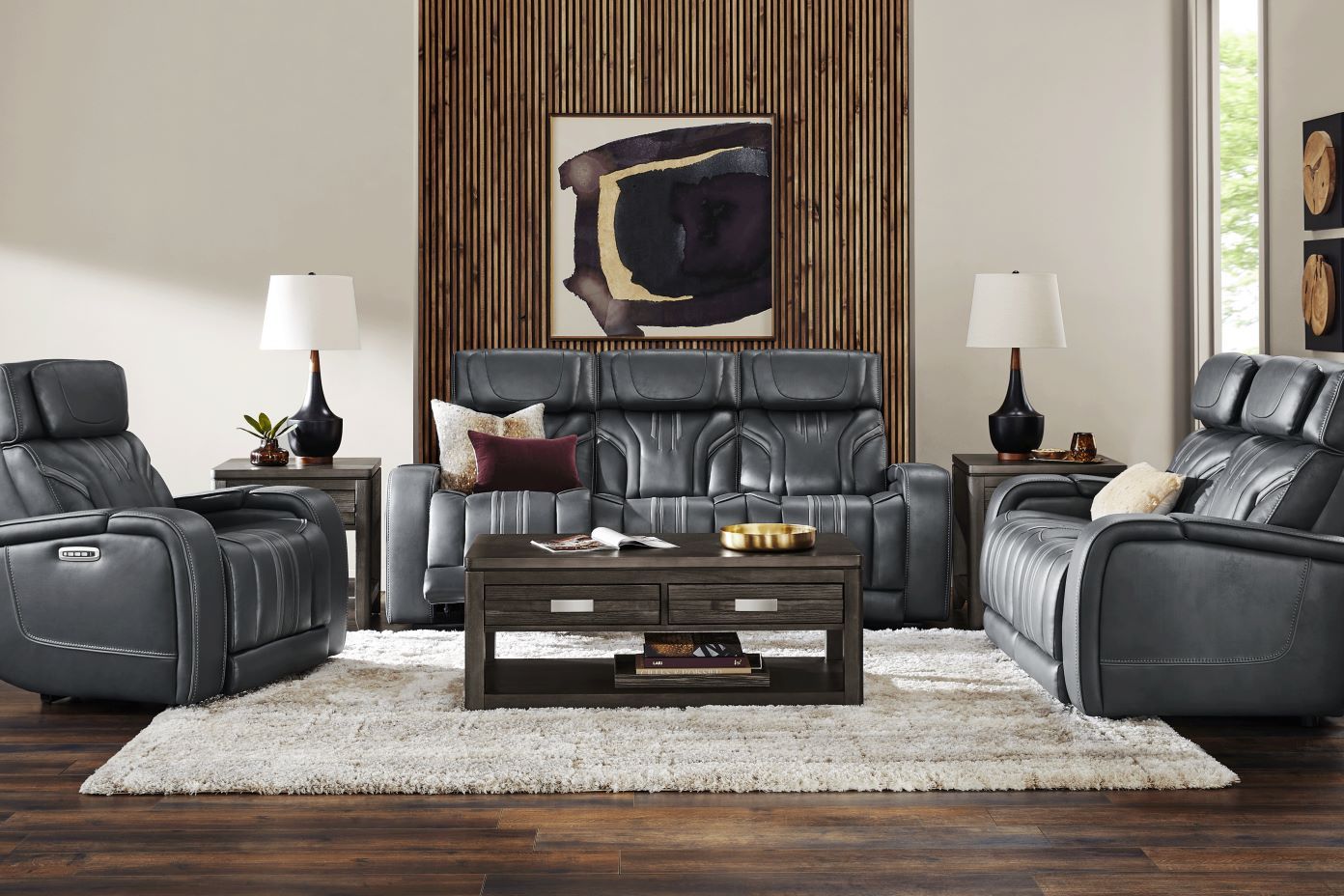 Living room with gray leather furniture, a coffee table, and a shaggy rug.
