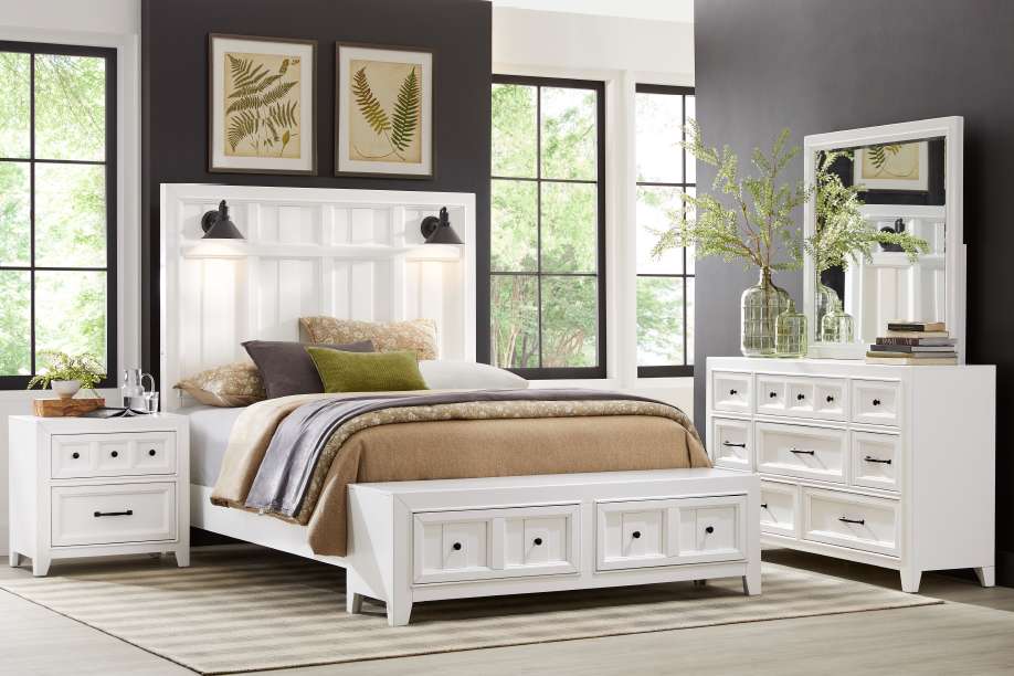 White bedroom furniture set with a bed, nightstand, and dresser.

