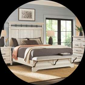 Bedroom set with a white bed frame, nightstands, and dresser.
