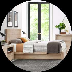 Bedroom with a wooden bed, nightstand, dresser, and large window.

