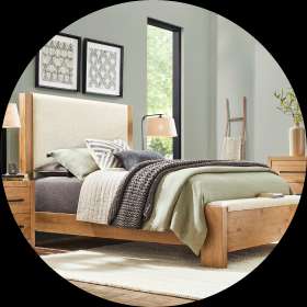 Wooden bed with a light-colored headboard, nightstands, and bedding.
