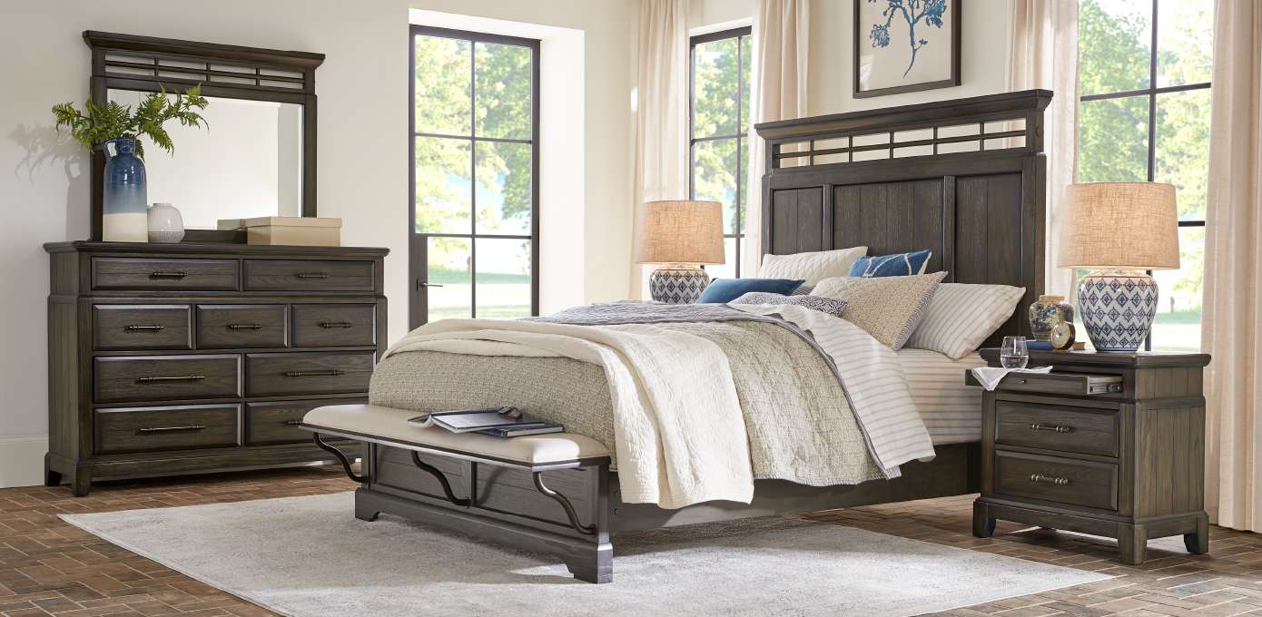 Bedroom furniture set with a bed, dresser, mirror, and nightstand.
