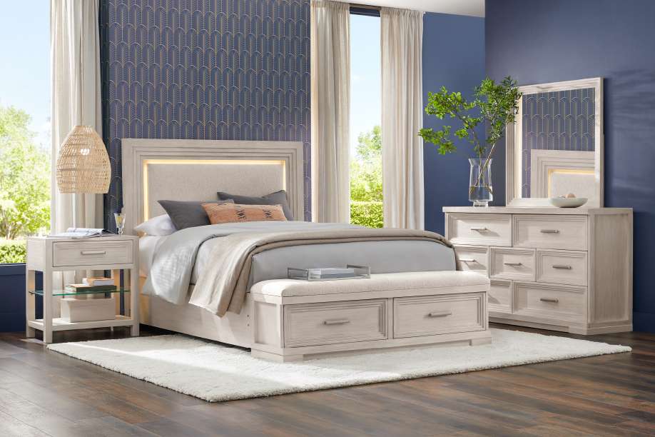 Bedroom furniture set with a bed, dresser, and nightstand.
