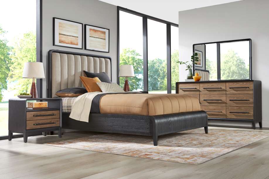 Bedroom furniture set with a bed, nightstand, dresser, and mirror.
